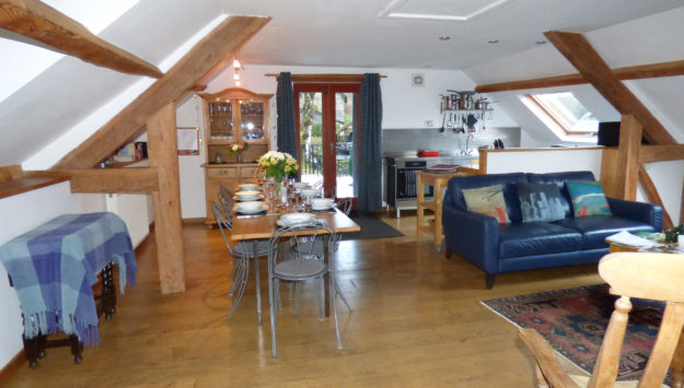 The living and dining area of the Loft, our couples cottage with hot tub