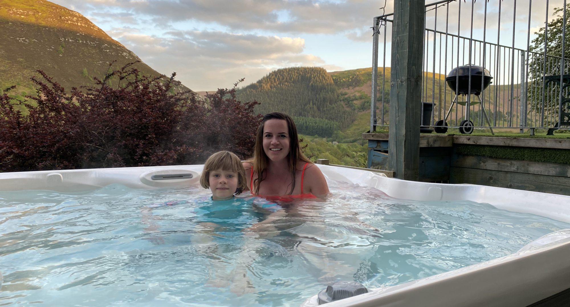 Mother and child enjoying their family lodge hot tub