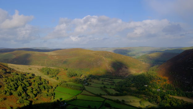 An aerial view of the Elan Valley cottage area, with rolling green hills and farmstays