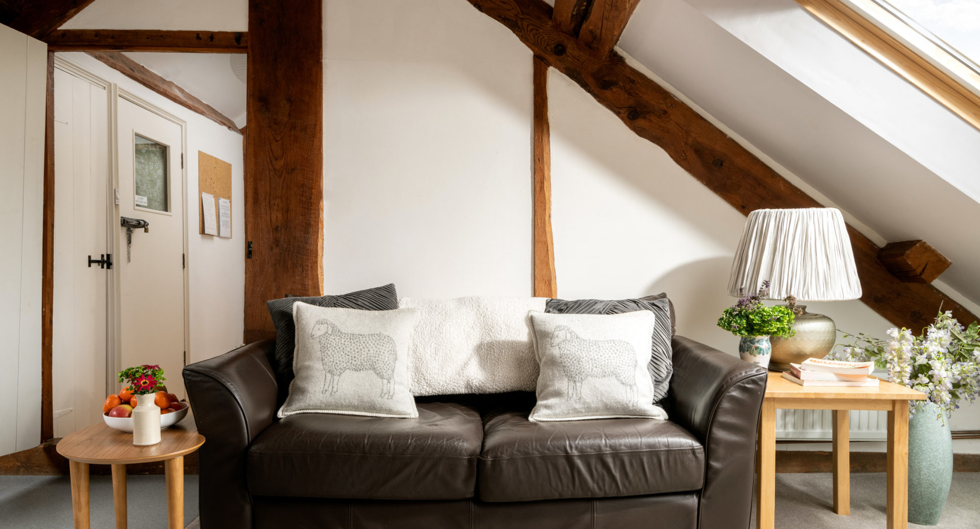 The sitting area in the small farm cottage with a cosy leather sofa