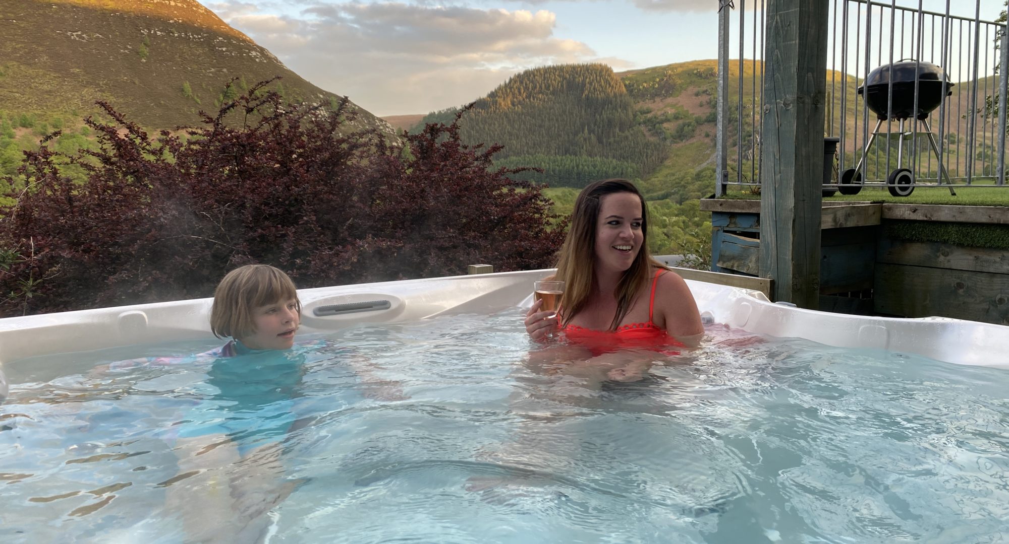 Parent and child in the family lodge hot tub