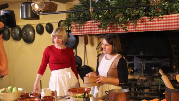 Two women in historical dress in a kitchen cottage near Hay on Wye