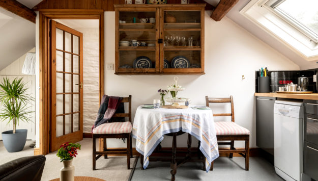 The dining and kitchen area of the cosy cottage for couples